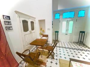 a dining room with a table and chairs and a door at Grand Villa in Amritsar +14 photos