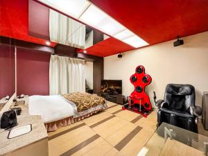 a bedroom with a bed and a guitar in a room at Fire Hotel Nw in Saitama
