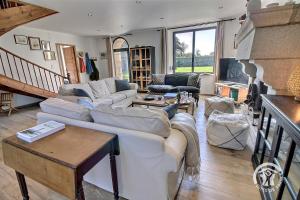 a living room with two couches and a table at La marie morgane in Lézardrieux