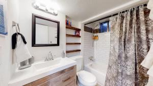 a bathroom with a sink and a toilet and a shower at Cozy Mountain-Inspired Lower Unit in Denver in Denver