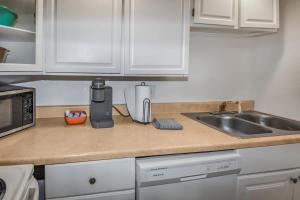 a kitchen counter with a coffee maker and a sink at Cozy Mountain-Inspired Lower Unit in Denver in Denver +9 photos