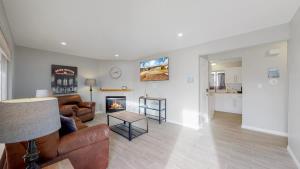 a living room with a couch and a fireplace at Bright & Cozy Upper Unit in Denver in Denver