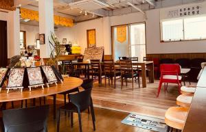 a restaurant with tables and chairs in a room at CCCOFFEE HOSTEL Kobe in Kobe