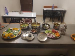 a table with many plates of food on it at Maa durga home stay in Faizābād +15 photos