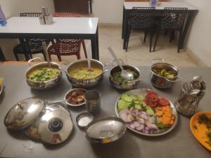 a bunch of bowls of food on a table at Maa durga home stay in Faizābād