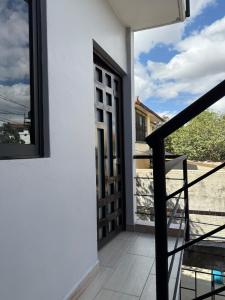a door to a balcony with a view at El Rinconcito Oaxaca - HiveNB in Santa Cruz Xoxocotlán