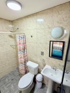 a bathroom with a toilet and a sink at El Rinconcito Oaxaca - HiveNB in Santa Cruz Xoxocotlán +5 photos