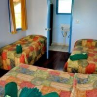 a hotel room with two beds and a television at Crab Claw Island in Bynoe Harbour