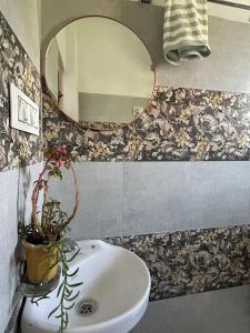 a bathroom with a sink and a mirror at Akása Homes by Cosmic Kriya in Palāhu +20 photos