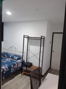 a bedroom with a bed and a chair in it at Homestay Daud in Bandar Permas