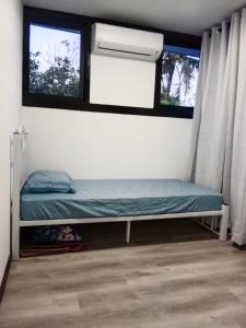 a small bed in a room with a window at Homestay Daud in Bandar Permas