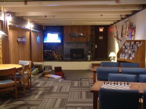 a waiting room with blue chairs and a fireplace at The Hostel in Teton Village