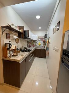 a large kitchen with a counter top at Luxe 3bhk bungalow Baner in Pune
