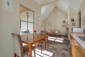 a kitchen and dining room with a table and chairs at CRABTREE RIVERFRONT COTTAGES 2 cottages EMILY & ELIZA COTTAGES Beautiful riverfront peaceful location RELAX & ENJOY in Huonville
