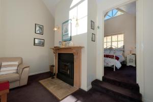 a living room with a fireplace and a couch at Crabtree Riverfront Cottages - Riverfront Relaxation in Grove