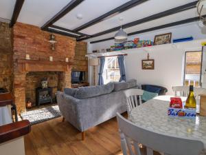 a living room with a table and a couch at Roseberry Cottage in Whitby
