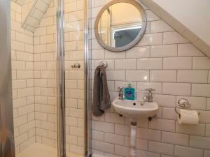 a bathroom with a sink and a mirror at Roseberry Cottage in Whitby +24 photos