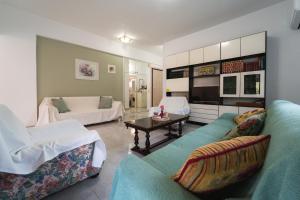 a living room with a couch and a table at Sea Zen in Paleo Tsifliki