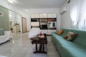 a living room with a green couch and a table at Sea Zen in Paleo Tsifliki +16 photos