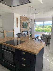 a kitchen with a island with a wooden counter top at Luxury Cottage, views of the Lakes with Hot Tub in Cockermouth