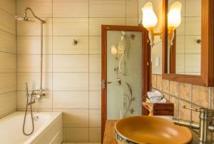 a bathroom with a sink and a tub and a shower at Snow Lion Riverside Resort in Yangshuo +79 photos