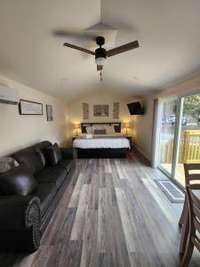 a living room with a couch and a bed at Relaxing Studio Cottage with Parking in Pigeon Forge