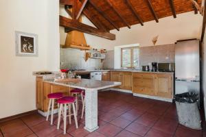 a kitchen with a large island with bar stools at Turismo Rural No Gerês in Carvalheira