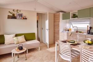 a living room with a couch and a table at Domaine MON CALME in Piriac-sur-Mer