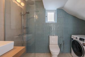 a bathroom with a shower and a toilet and a sink at East of Preveli Seafront Villas by TheCreteEscape in Kerames +16 photos