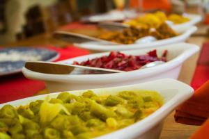 a row of bowls filled with food on a table at Ranna Beach House in Ranna