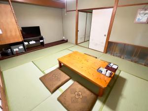 Higashi-komi国民宿舎古岩屋荘的空房间,配有木桌和凳子