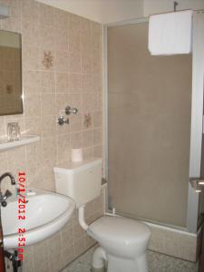 a bathroom with a white toilet and a sink at Hotel Feilen-Wolff in Trier