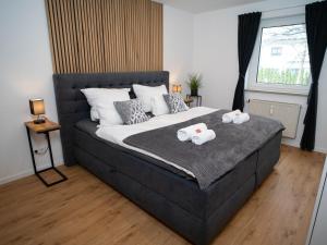 a bedroom with a bed with two towels on it at MOREHOME-Apartments in Mindelheim