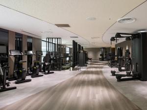 a gym with lots of treadmills and machines at RIHGA Royal Hotel Osaka, Vignette Collection by IHG in Osaka