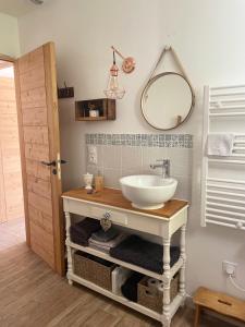 a bathroom with a sink and a mirror at Le nid du vallon in Pomport