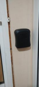 a door with a black box on the side of it at Apartment Bela in Burgas City
