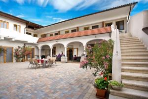 a courtyard of a building with a table and chairs at Weingut Franz Schindler in Mörbisch am See