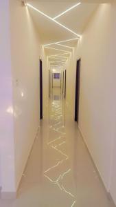 an empty hallway with white walls and white floors and ceilings at SSK Rooms in Gūduvāncheri