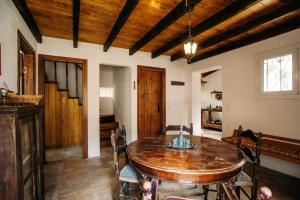 a dining room with a wooden table and chairs at Krasospito 1850 - a Corfiot Wine House Reborn in Lefkimmi +64 photos