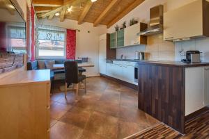 a kitchen with a counter and a table in it at Apartment Wallner in Fieberbrunn