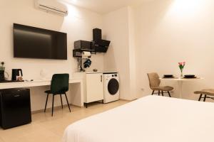 a hotel room with a bed and a tv on the wall at Dimora Zonno in Bari