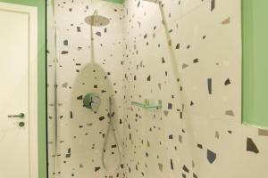 a bathroom with a rock wall with a climbing wall at Dimora Zonno in Bari