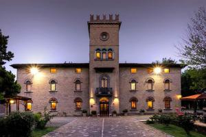 a large stone building with a clock tower at Hotel Castello in Modena