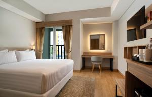Vuode tai vuoteita majoituspaikassa Vega Hotel Gading Serpong