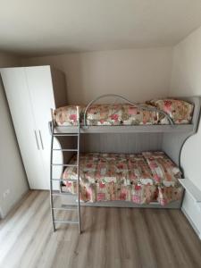 a bedroom with two bunk beds in a room at Mary House in Ossimo