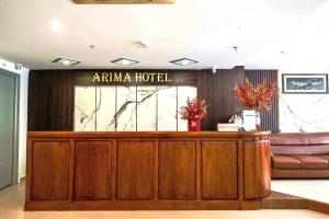 a hotel lobby with a hotel sign on the wall at Arima Hotel Nha Trang Beach by HC Group in Nha Trang