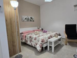 a bedroom with a bed and a table and a lamp at Maclas Apartment -Vasto Centro Storico- in Vasto