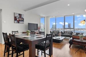 a living room with a table and a couch at Harbourfront Urban Oasis in Melbourne