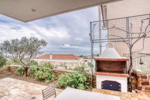 an outdoor patio with a brick oven on a house at Asprou Villa with roof pool in Vrontados