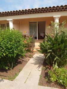 a house with a porch and some plants at L'orangerai d'Antibes in Antibes